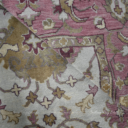 The soft, hand-knotted texture and muted colors of this Oushak rug