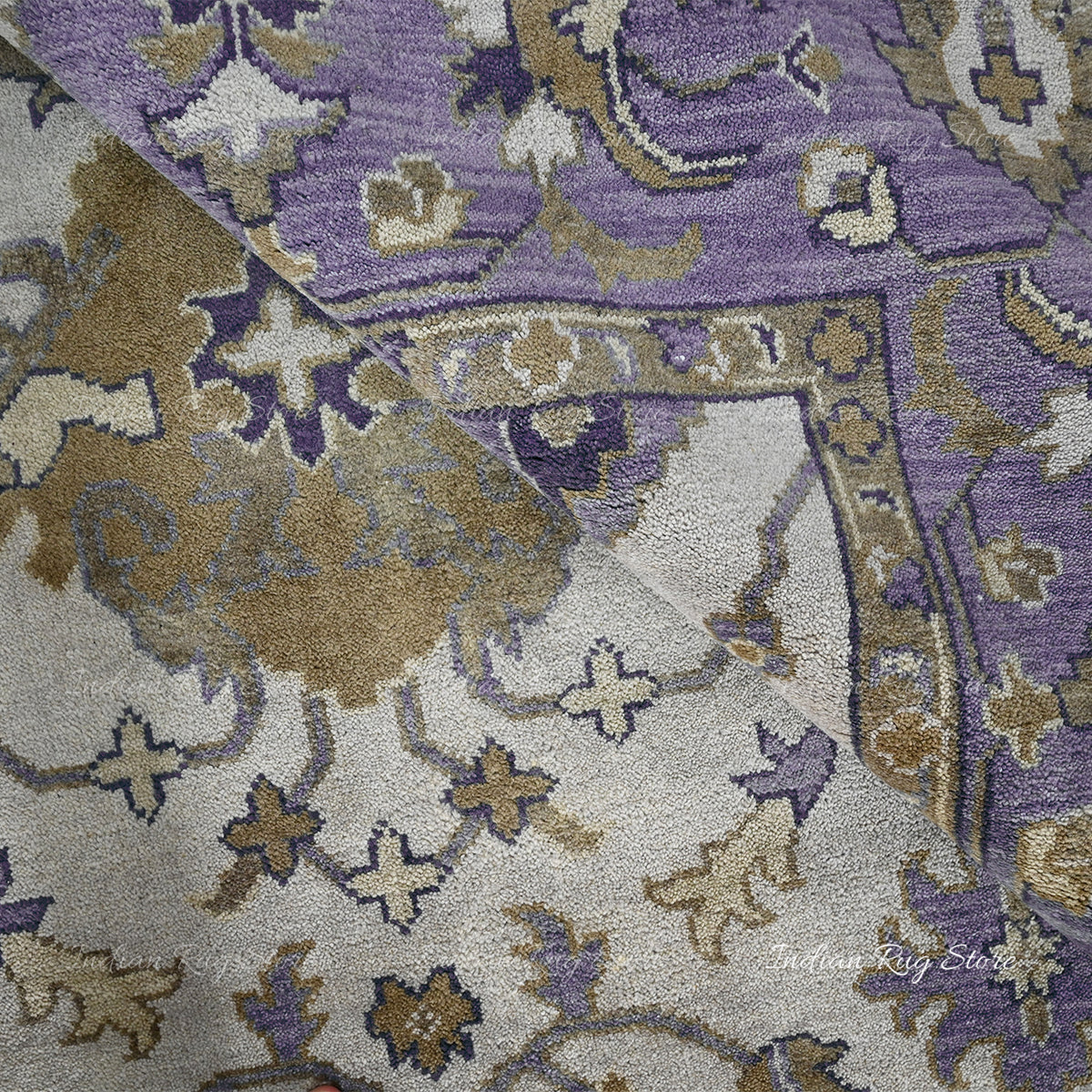 A close-up shot of the delicate weave and subtle, faded hues of this Oushak rug.